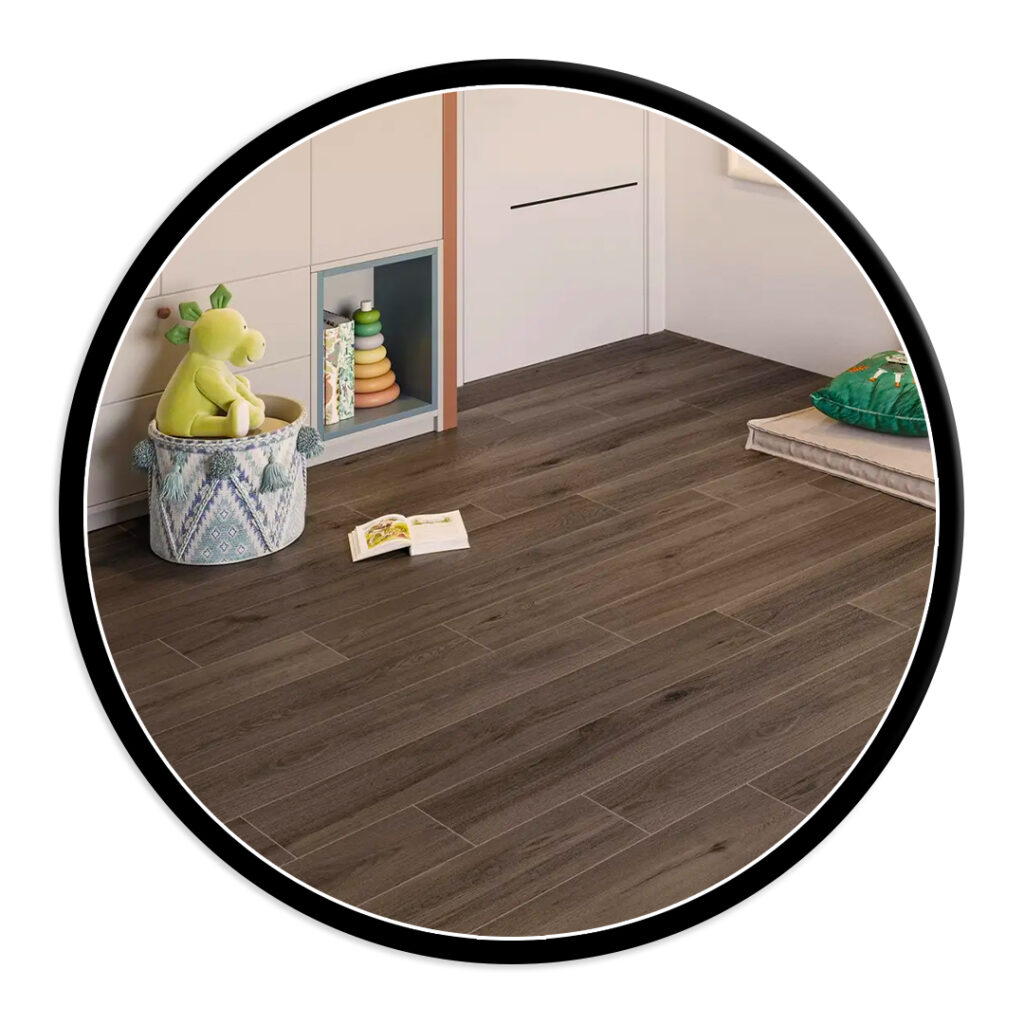 Playful kids' corner with a basket holding a green plush toy, a stacking ring toy in a cubby, an open book on a dark wood floor, and a mat with a green pillow nearby.