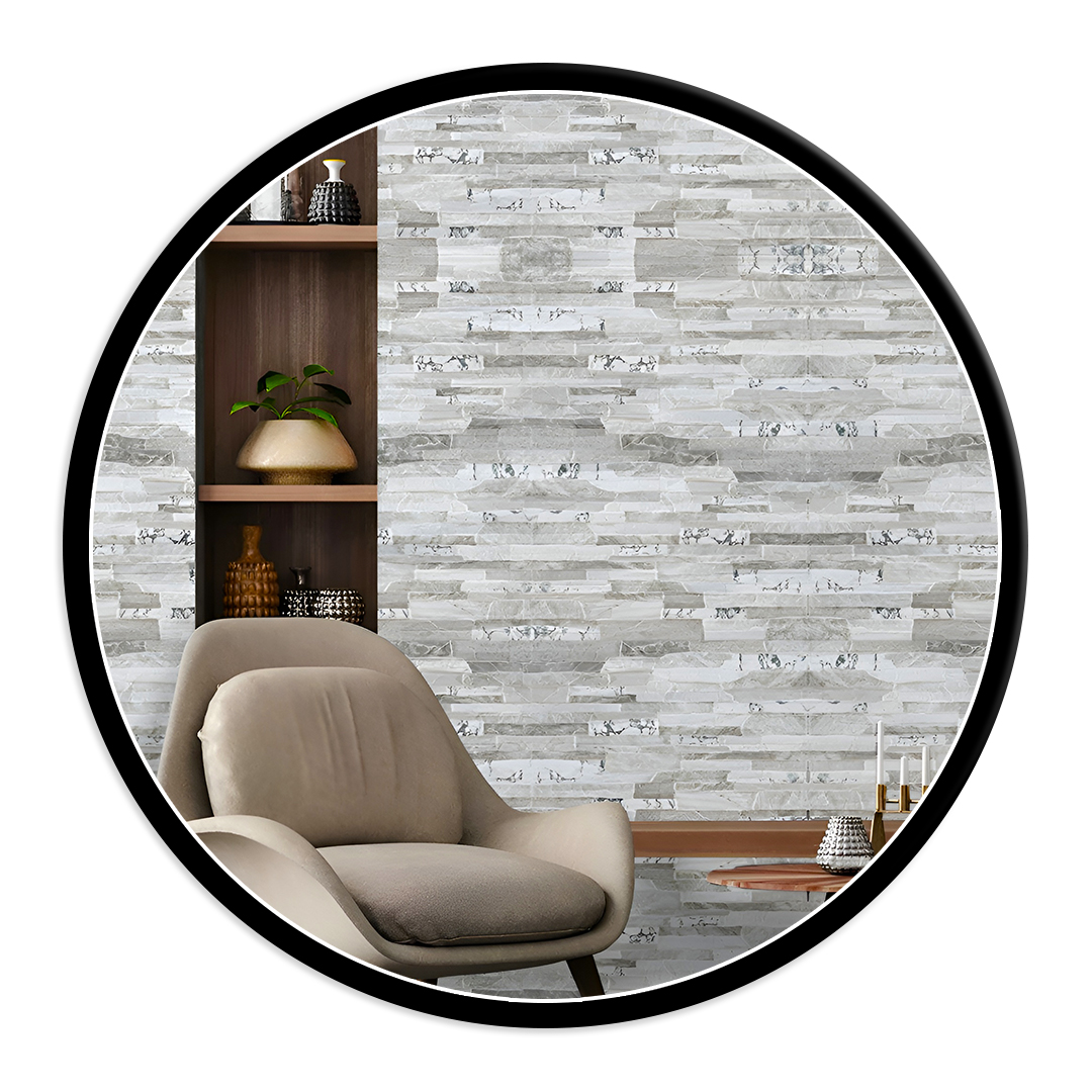 Circular view of a cozy modern living area: beige lounge chair in front of a textured gray stone wall, with a wooden shelf of vases and a small plant on the left and a low coffee table with candles on the right.